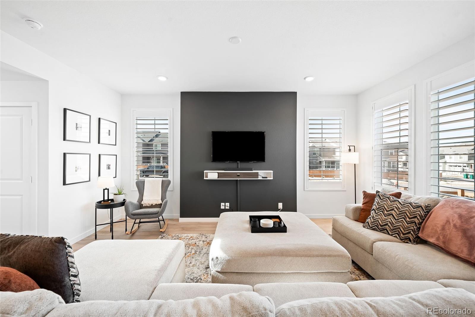 16249 Laurentide Place Parker, CO 80134 - Photo 6 of 30 a living room with furniture and a flat screen tv