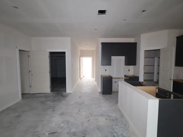 a room with refrigerator and cabinets