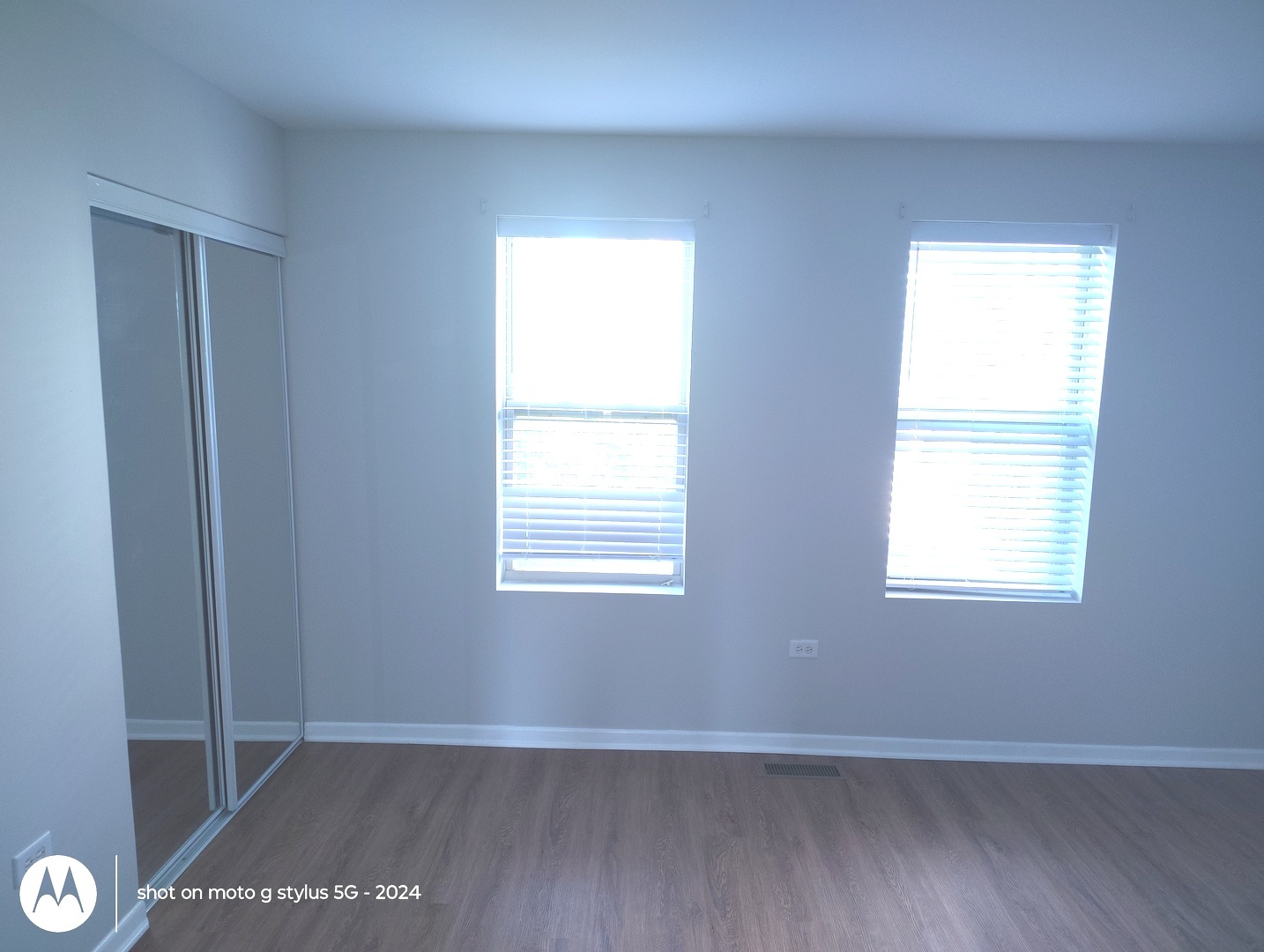 2367 East 70th Place, Unit 1A Chicago, IL 60649 - Photo 14 of 30 a view of an empty room with wooden floor and a window