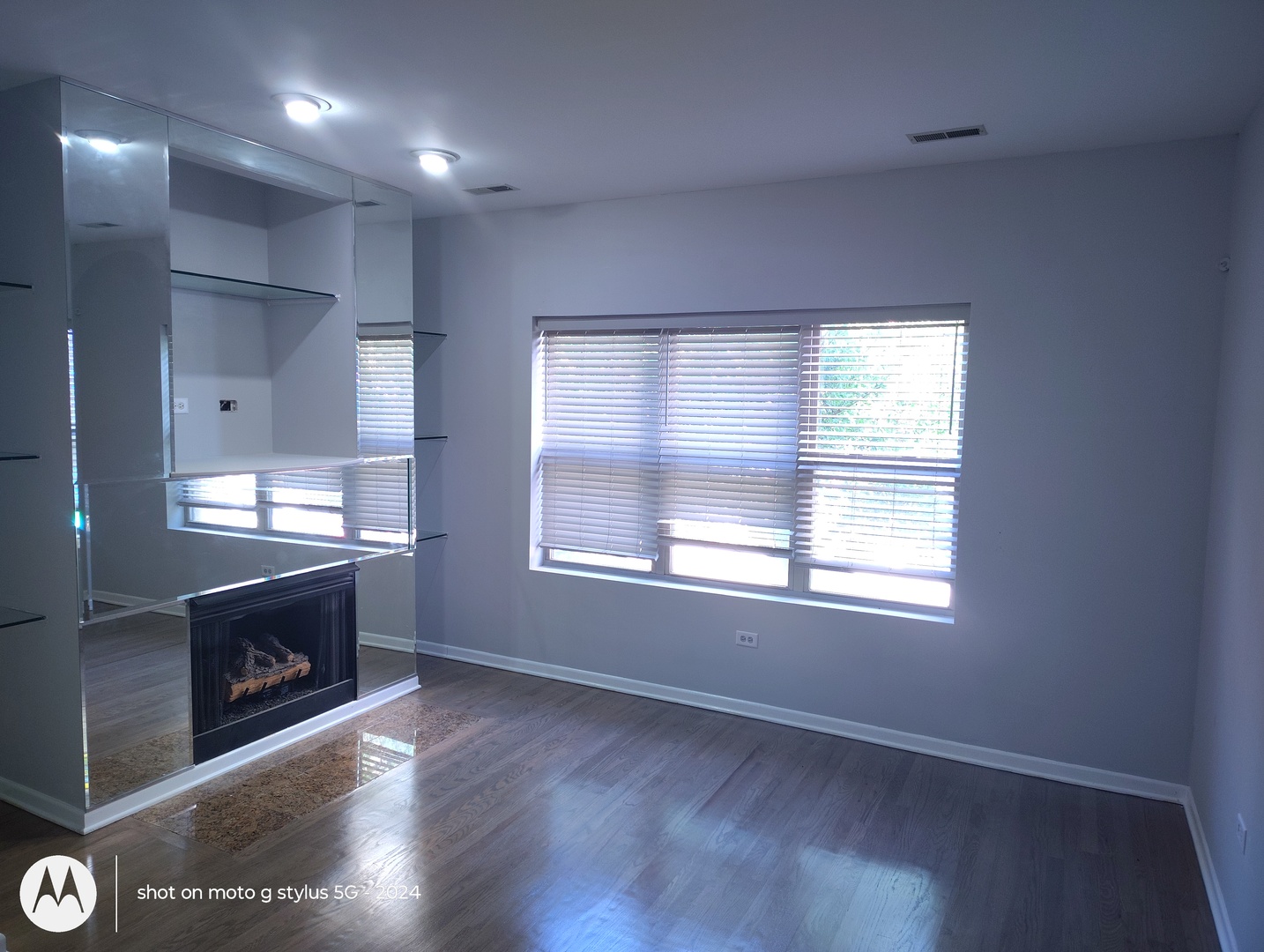 2367 East 70th Place, Unit 1A Chicago, IL 60649 - Photo 16 of 30 an empty room with wooden floor and windows
