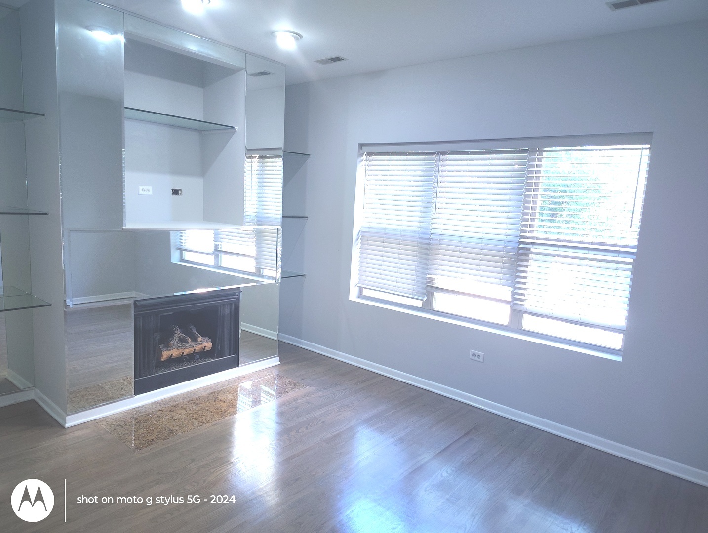 2367 East 70th Place, Unit 1A Chicago, IL 60649 - Photo 2 of 30 a view of an empty room with window and wooden floor