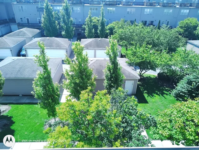 an aerial view of a house with a yard and garden in back