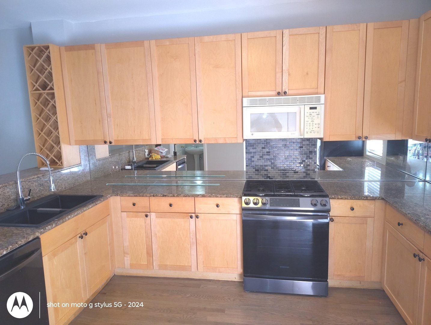 2367 East 70th Place, Unit 1A Chicago, IL 60649 - Photo 3 of 30 a kitchen with granite countertop a sink a stove and cabinets