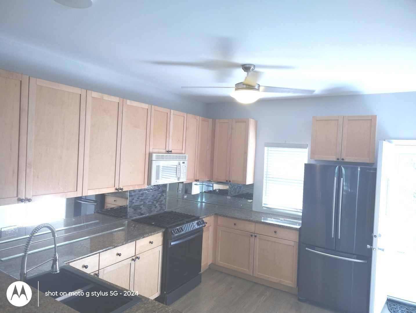 2367 East 70th Place, Unit 1A Chicago, IL 60649 - Photo 4 of 30 a kitchen with granite countertop a refrigerator a sink and dishwasher