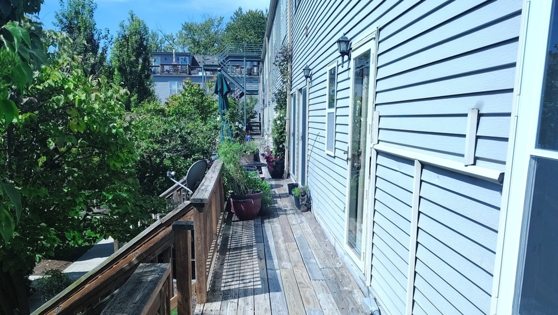 2367 East 70th Place, Unit 1A Chicago, IL 60649 - Photo 7 of 30 a view of a balcony with wooden floor and stairs