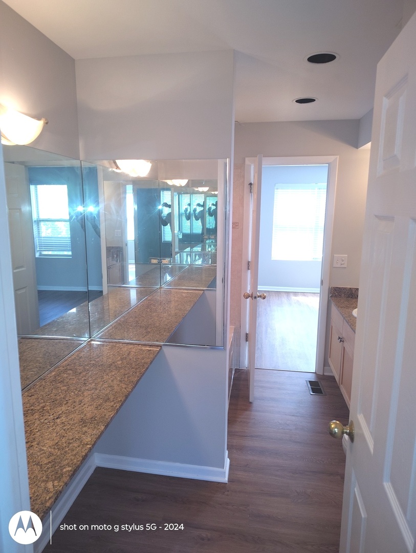 2367 East 70th Place, Unit 1A Chicago, IL 60649 - Photo 10 of 30 a view of a hallway view with wooden floor and staircase