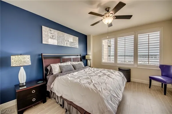 a bedroom with a large bed and a flat screen tv