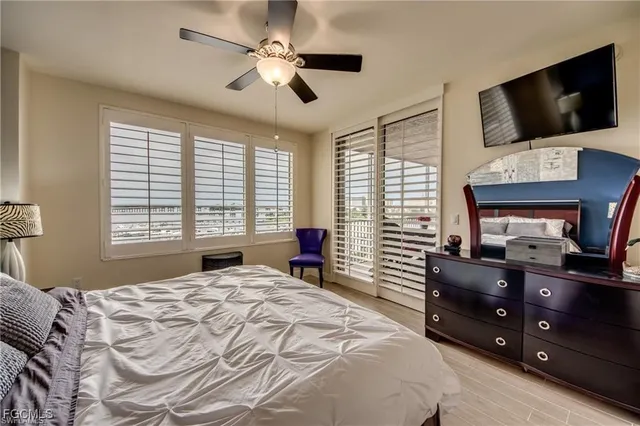 a bedroom with a large bed and a flat screen tv