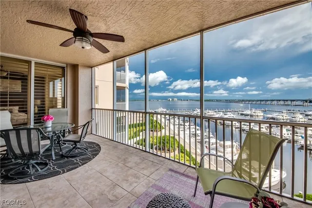 a view of a chairs and table in patio with a small pool
