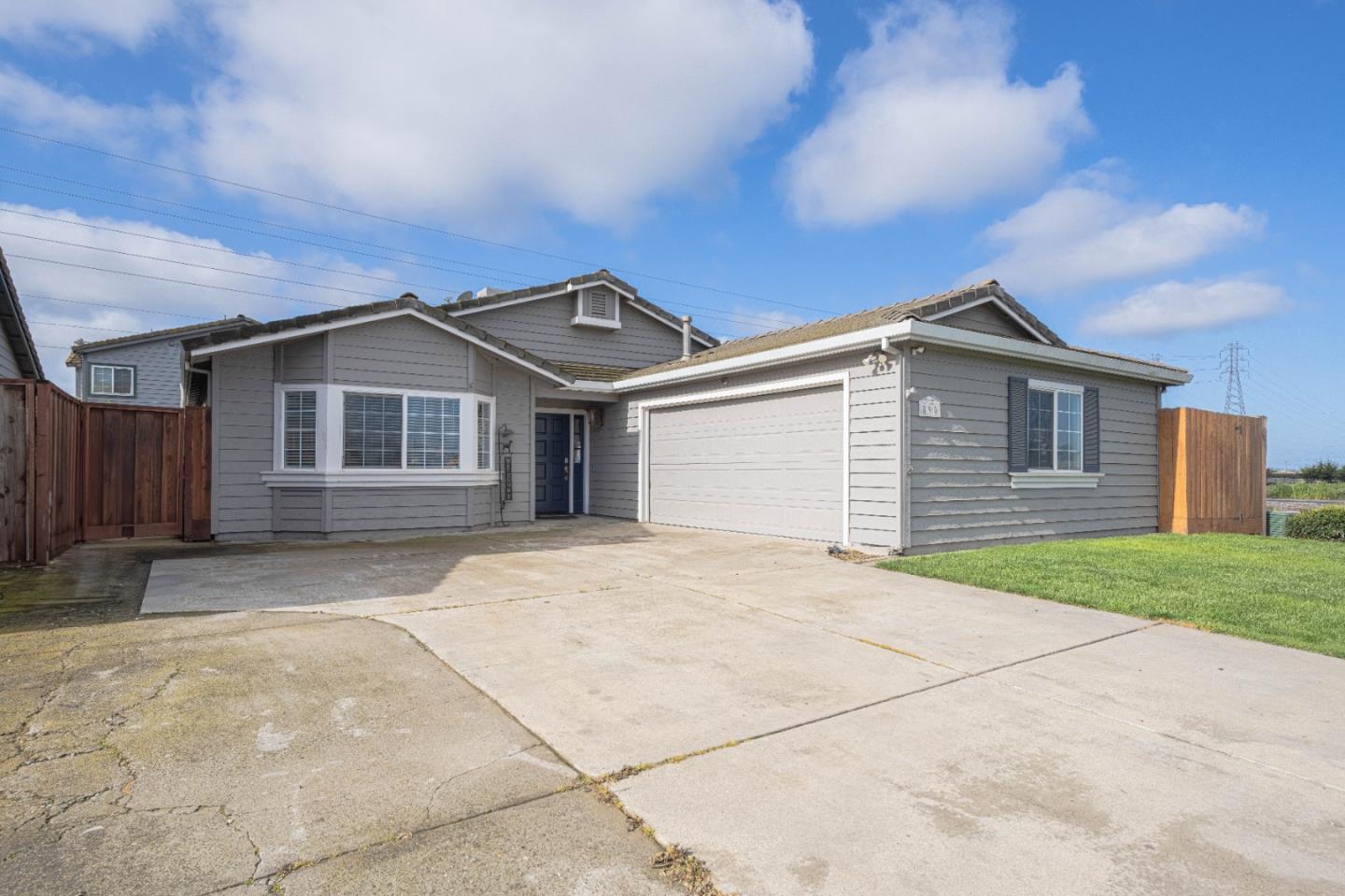a front view of a house with a garden and yard