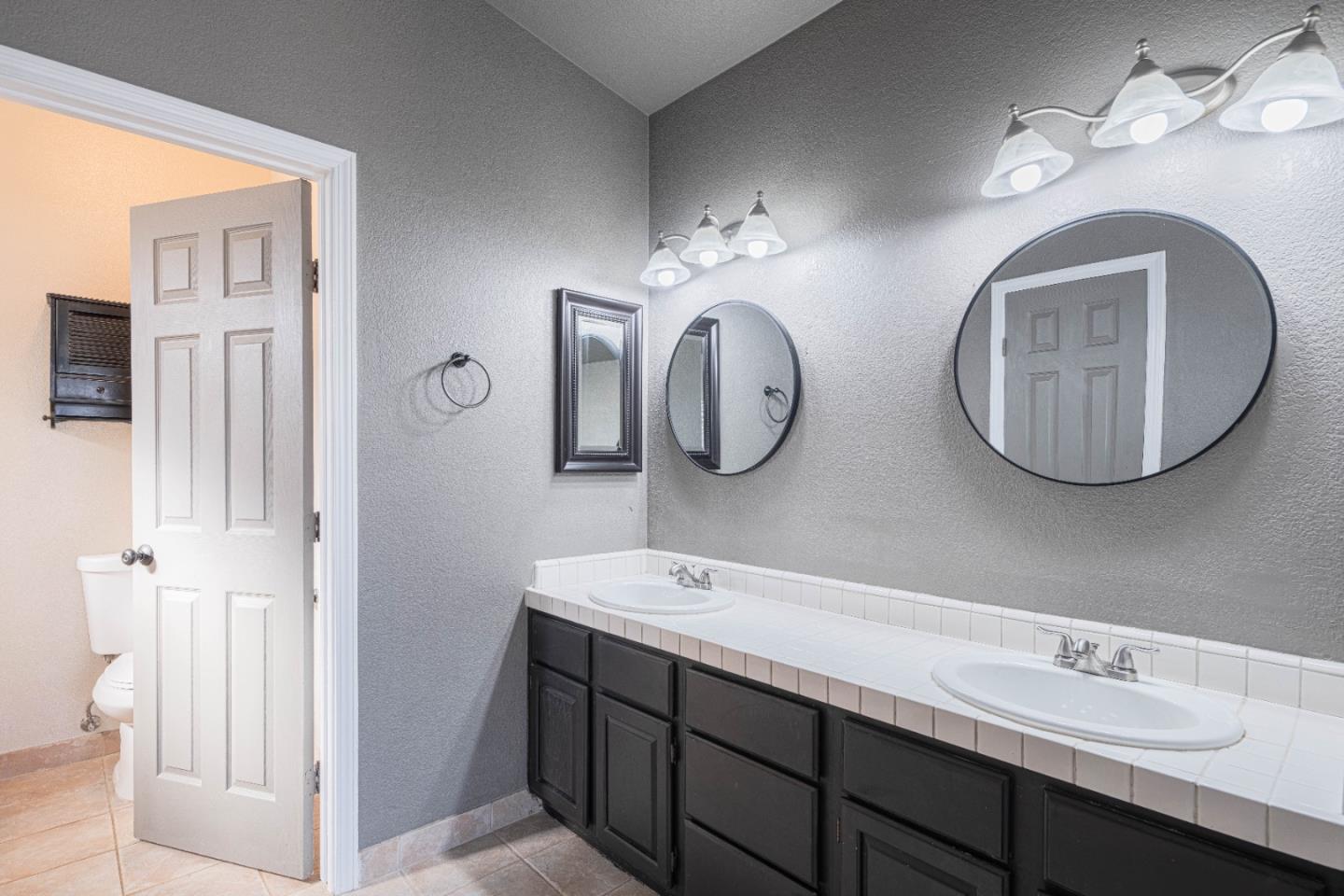 890 Sloat Drive Salinas, CA 93907 - Photo 17 of 37 a bathroom with a double vanity sink mirror and
