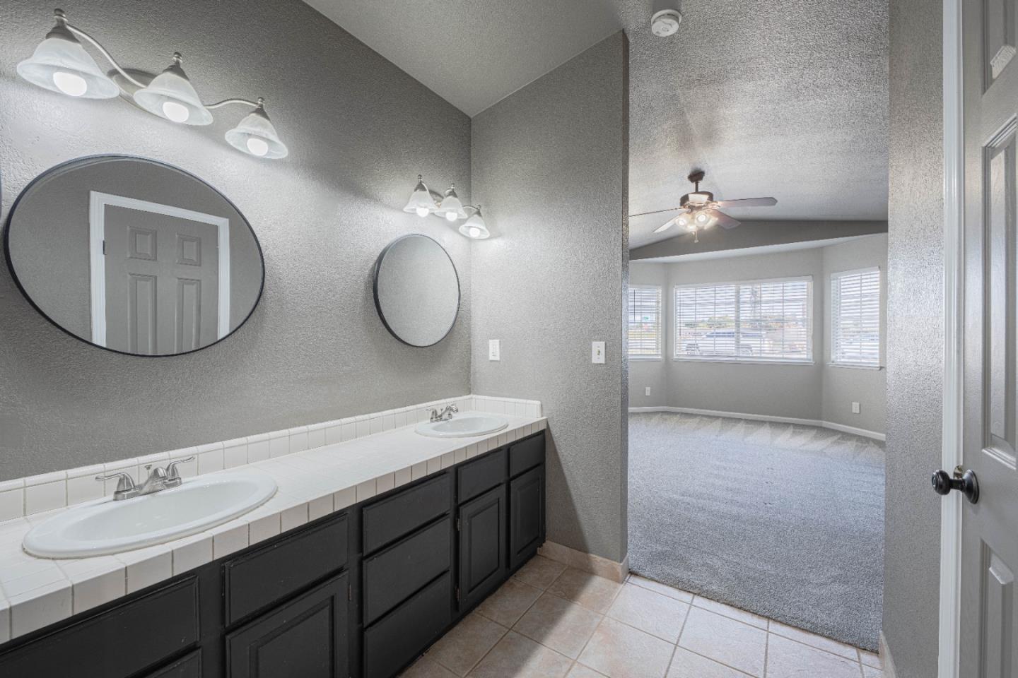 890 Sloat Drive Salinas, CA 93907 - Photo 19 of 37 a bathroom with a double vanity sink mirror and bathtub