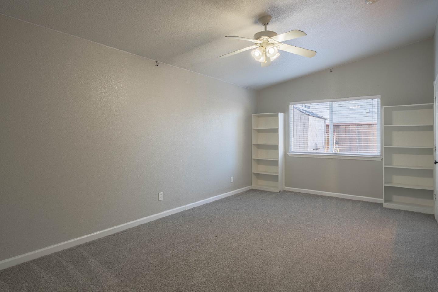 890 Sloat Drive Salinas, CA 93907 - Photo 21 of 37 an empty room with windows and fan