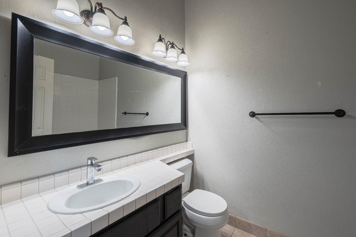 890 Sloat Drive Salinas, CA 93907 - Photo 27 of 37 a bathroom with a sink vanity mirror and toilet