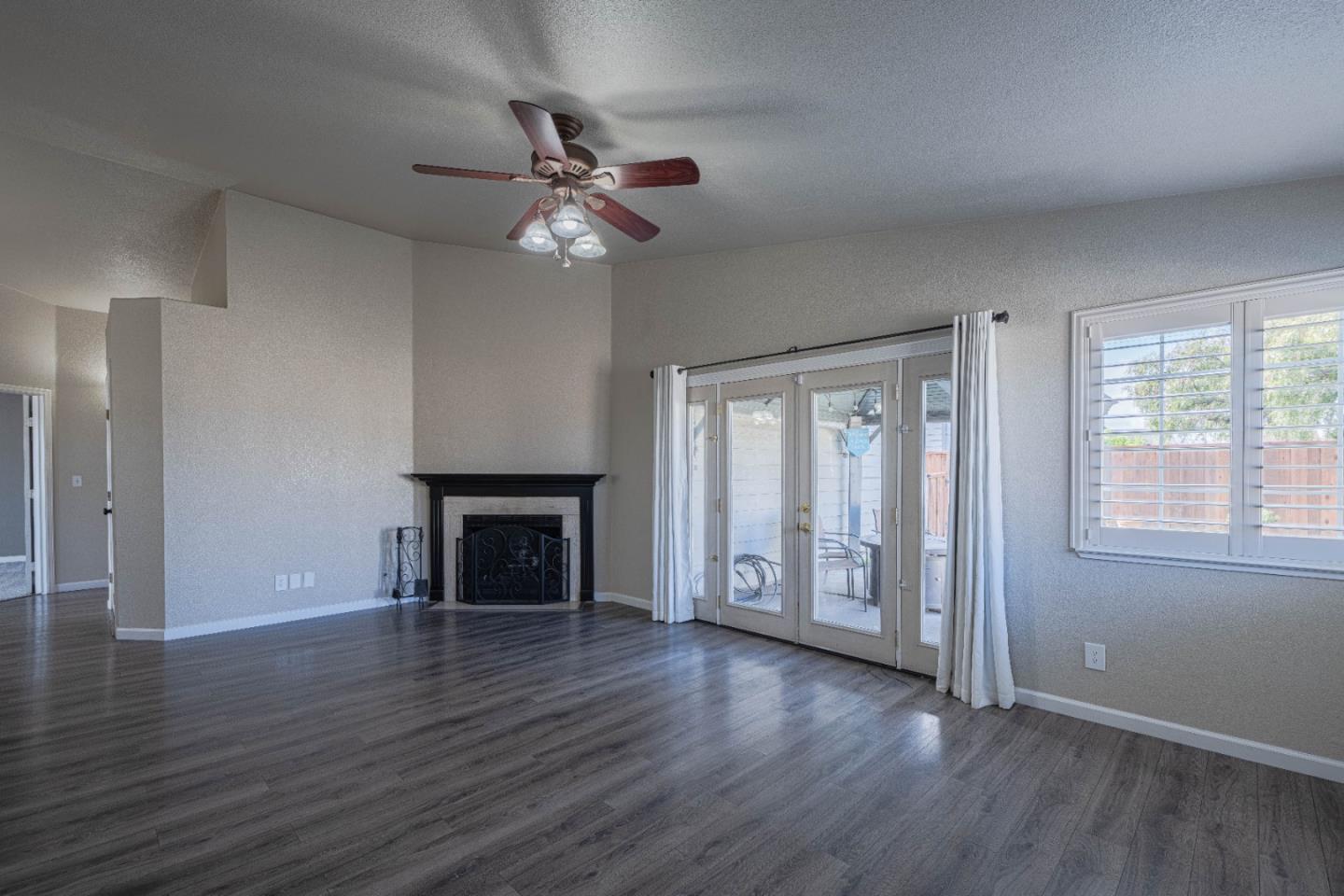 890 Sloat Drive Salinas, CA 93907 - Photo 5 of 37 a view of an empty room with a window and wooden floor