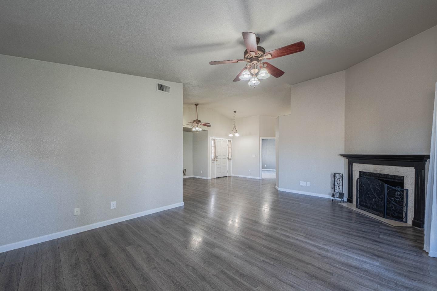890 Sloat Drive Salinas, CA 93907 - Photo 6 of 37 a view of an empty room with wooden floor and a fireplace