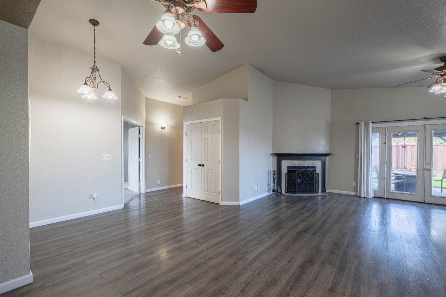 890 Sloat Drive Salinas, CA 93907 - Photo 9 of 37 a view of an empty room with wooden floor fireplace and a window
