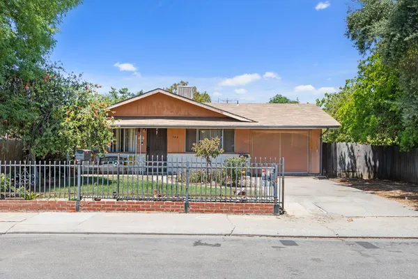 a view of a house with a iron fence