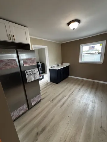a kitchen with stainless steel appliances wooden cabinets and a stove top oven