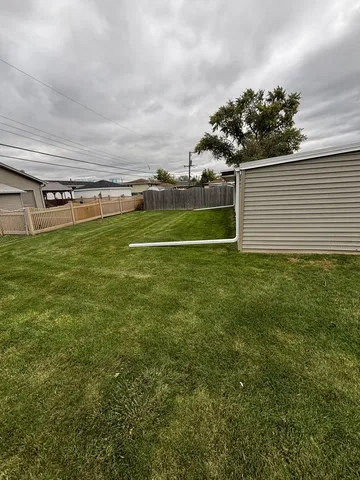 a view of a field of grass and trees