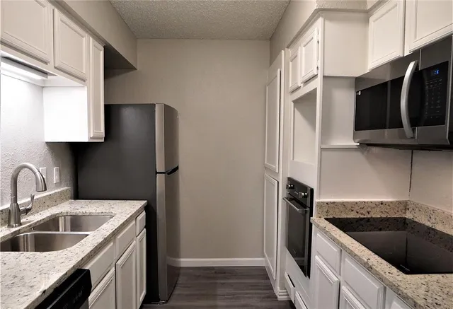 a kitchen with a sink stove and refrigerator