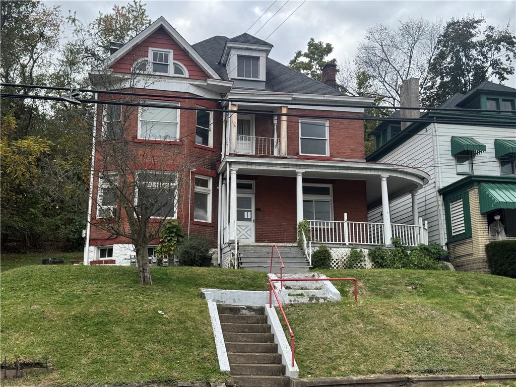 221 Singer Avenue McKees Rocks, PA 15136 - Photo 1 of 23 front view of a brick house with a yard
