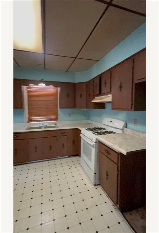 221 Singer Avenue McKees Rocks, PA 15136 - Photo 2 of 23 a kitchen with stainless steel appliances a sink and a stove