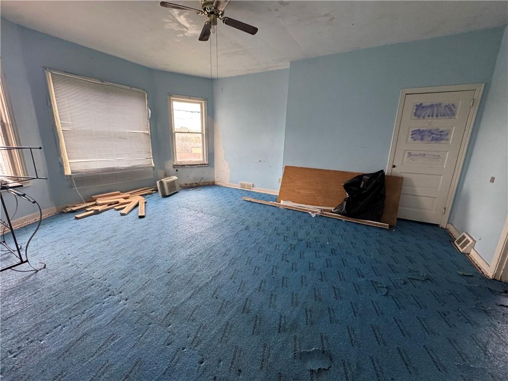221 Singer Avenue McKees Rocks, PA 15136 - Photo 10 of 23 an empty room with wooden floor and windows