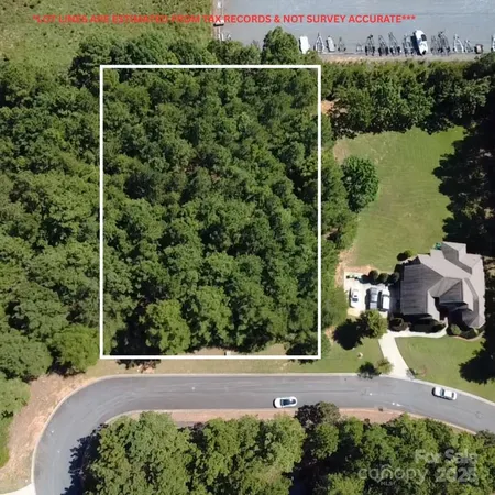 an aerial view of a house with a garden and lake view