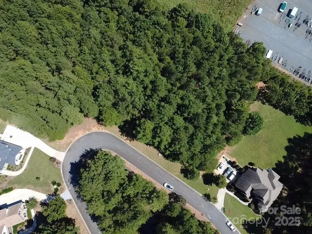 an aerial view of a house with a yard and outdoor seating