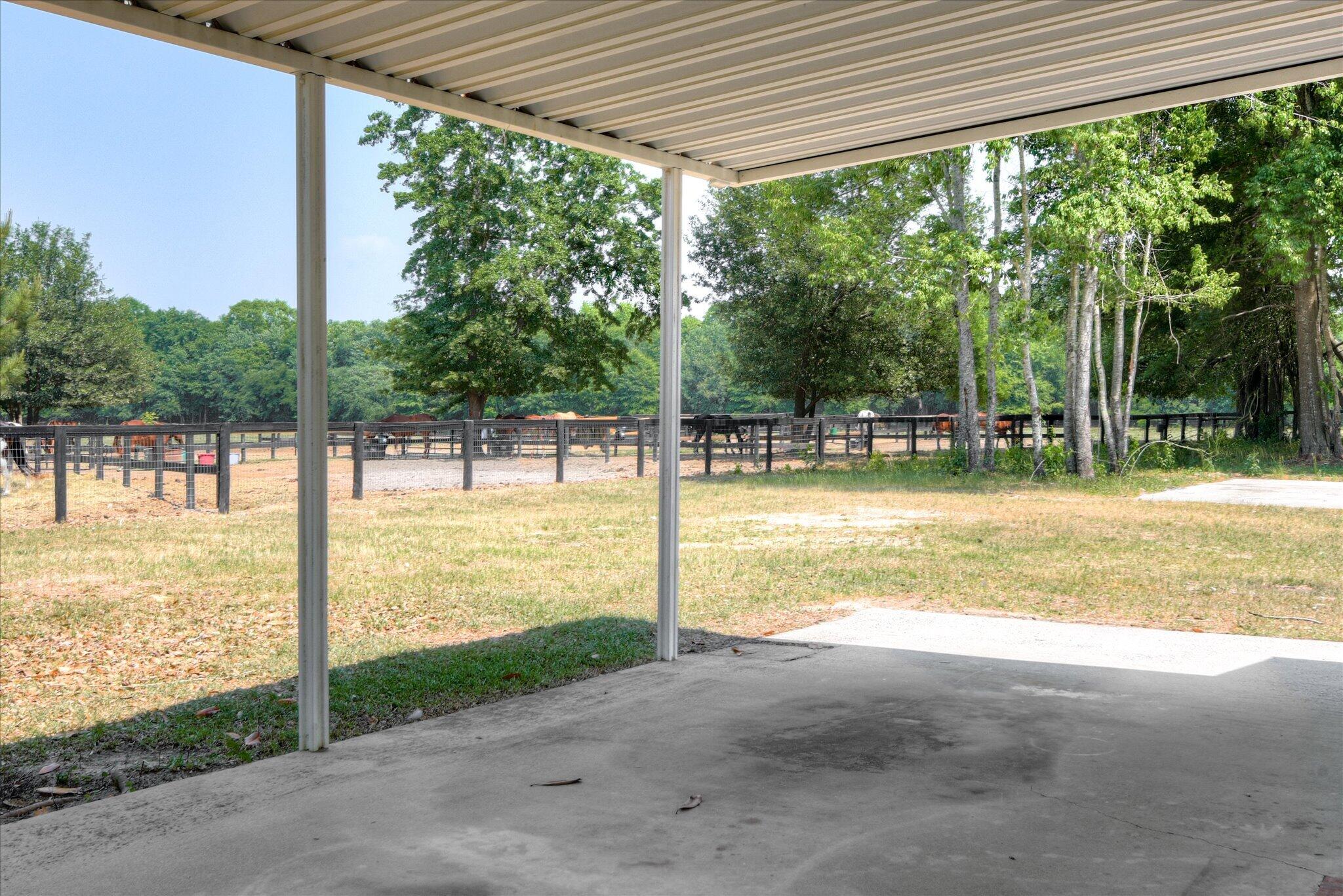 126 Mosley Road Aiken, SC 29801 - Photo 27 of 29 a view of a porch with a floor to ceiling window next to a yard