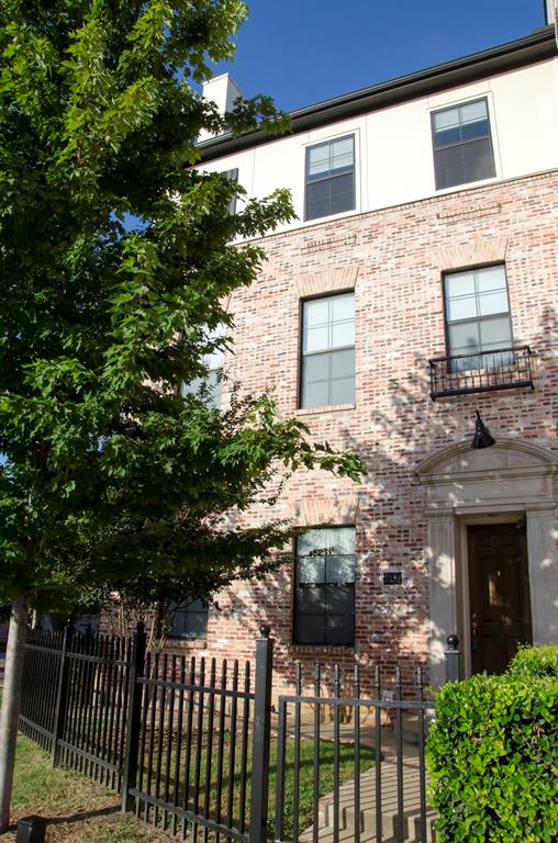 a front view of a house with a brick wall