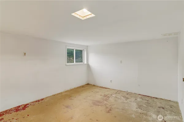 an empty room with a empty space and a window