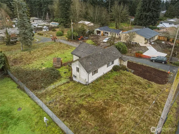 a large house with a big yard and large trees