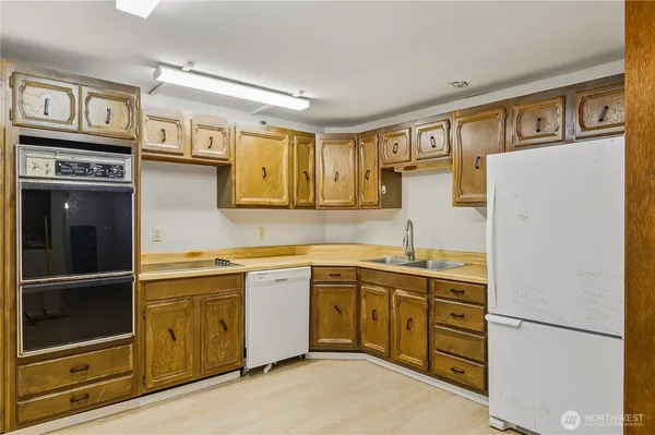 a kitchen with stainless steel appliances granite countertop a refrigerator and a stove top oven