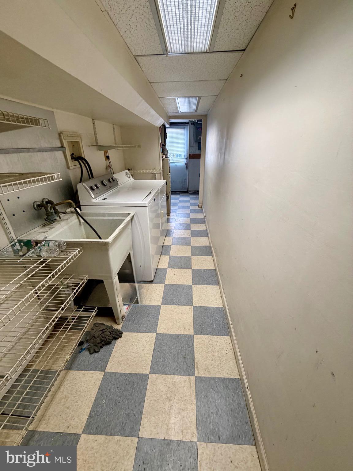 868 Fairfax Road Drexel Hill, PA 19026 - Photo 16 of 16 a hallway with a black white checkered floor with white walls