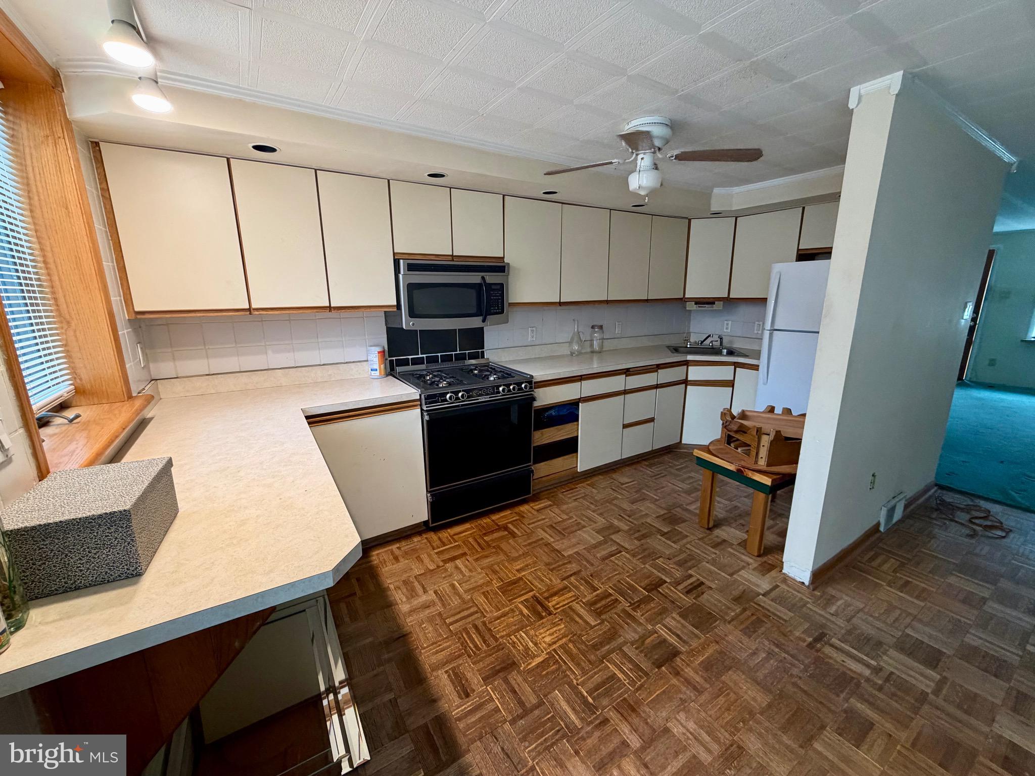 868 Fairfax Road Drexel Hill, PA 19026 - Photo 7 of 16 a kitchen with stainless steel appliances granite countertop a stove top oven a sink dishwasher and a refrigerator