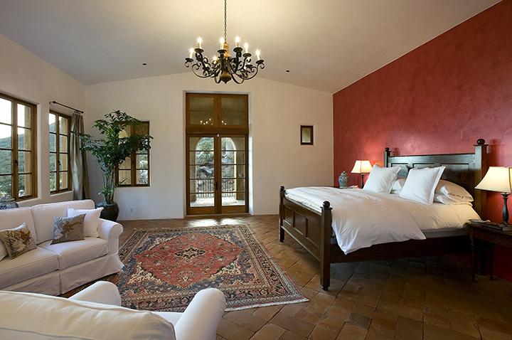 2790 Bella Vista Drive Montecito, CA 93108 - Photo 8 of 9 a spacious bedroom with a bed and a chandelier