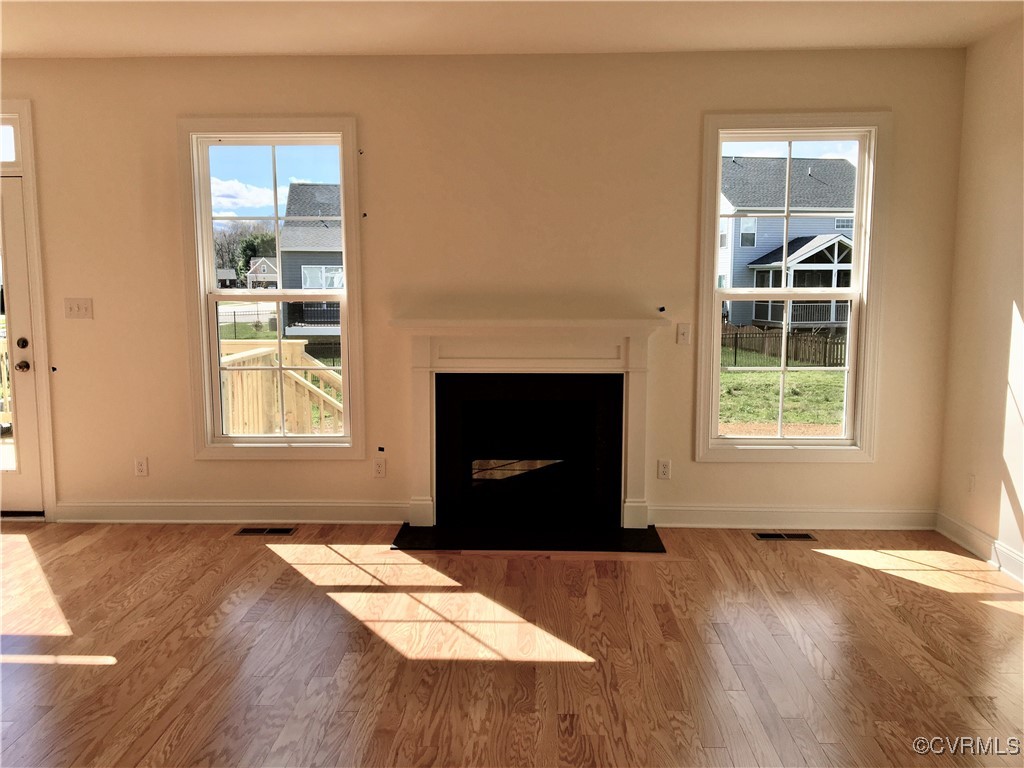 8423 Bishops Park Drive Mechanicsville, VA 23116 - Photo 8 of 17 an empty room with windows and fireplace