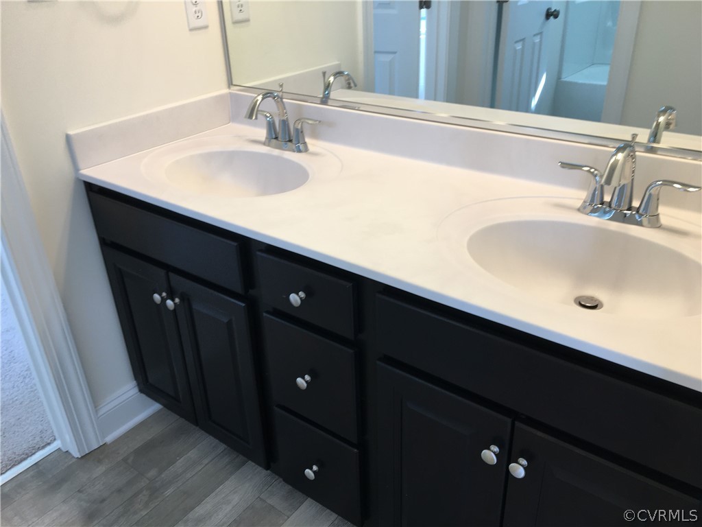 8423 Bishops Park Drive Mechanicsville, VA 23116 - Photo 10 of 17 a bathroom with a sink and a mirror