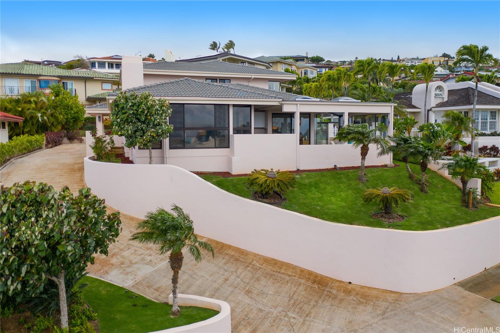 a front view of a house with a garden and yard