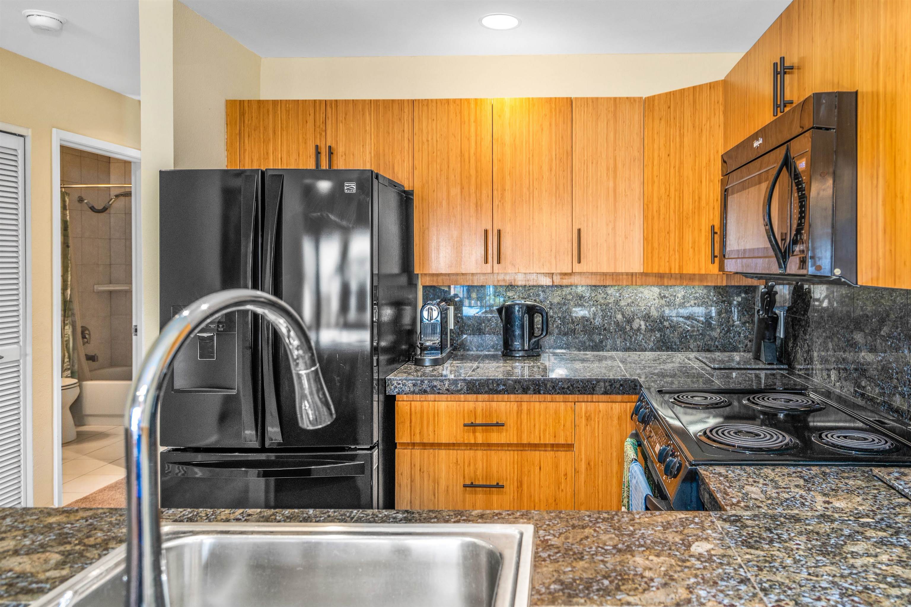 2777 South Kihei Road, Unit G207 Kihei, HI 96753 - Photo 12 of 50 a kitchen with a sink a stove and refrigerator