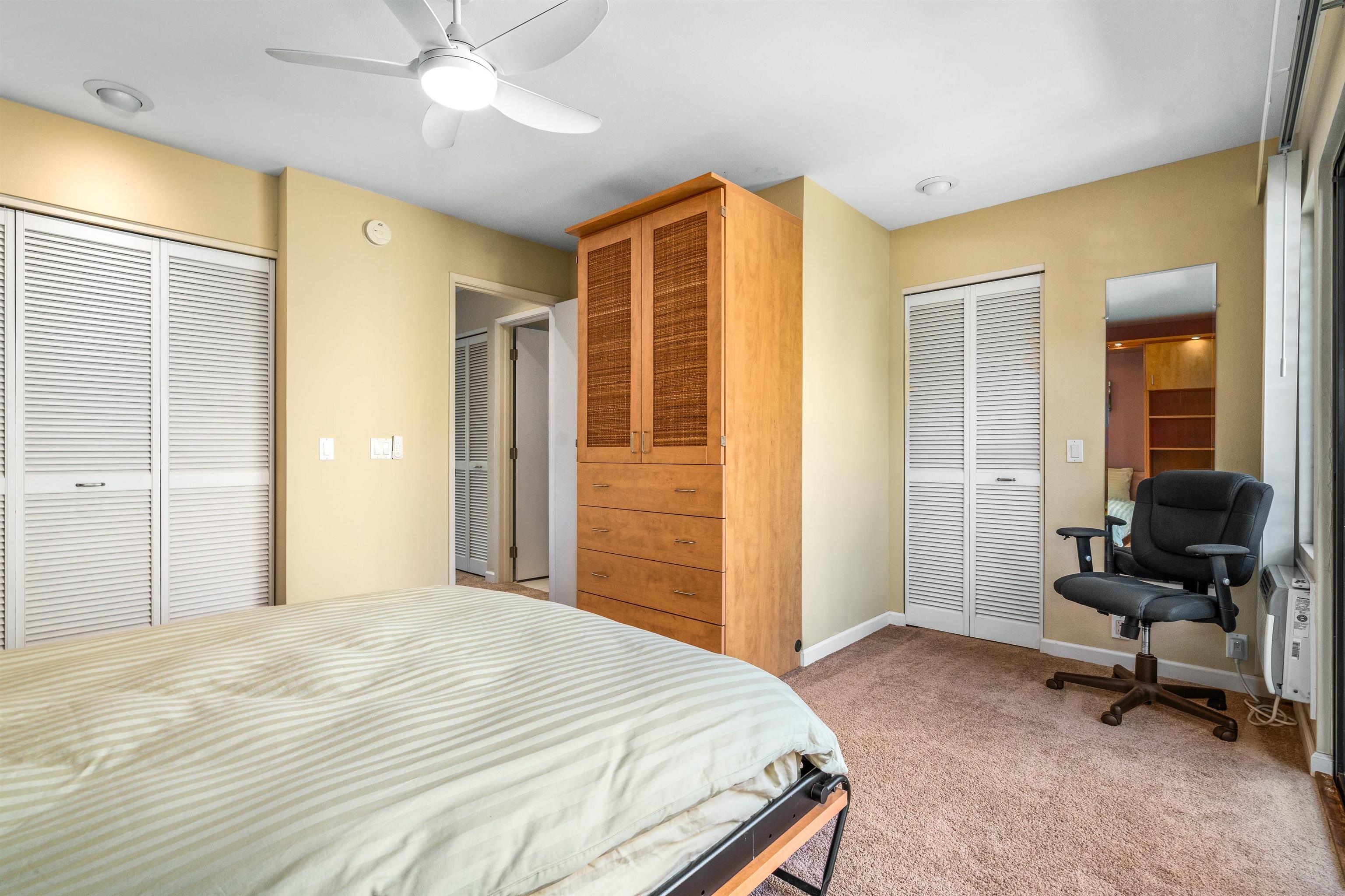 2777 South Kihei Road, Unit G207 Kihei, HI 96753 - Photo 23 of 50 a bedroom with a bed and a chandelier