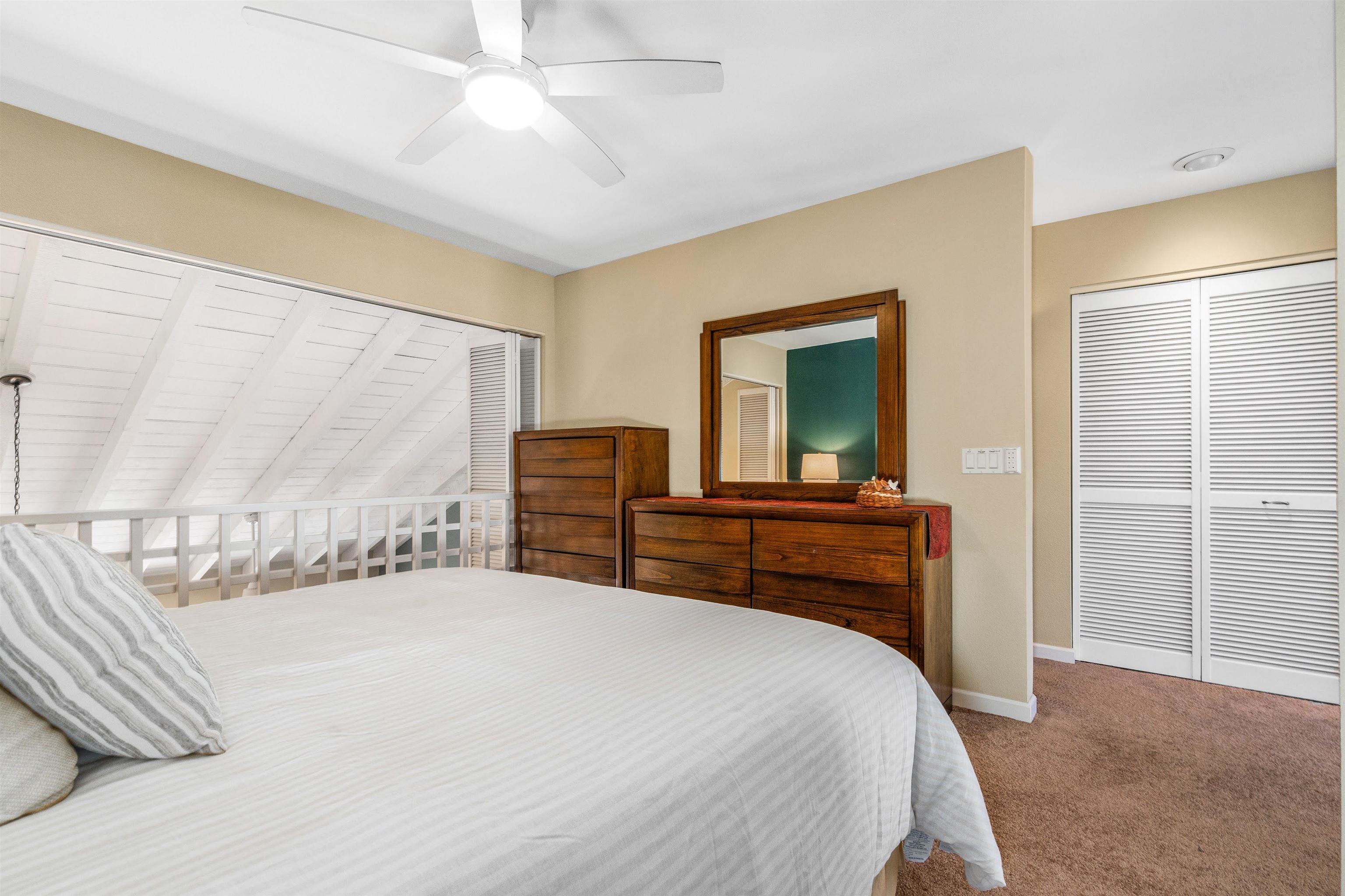 2777 South Kihei Road, Unit G207 Kihei, HI 96753 - Photo 31 of 50 a bedroom with a large bed and a chandelier