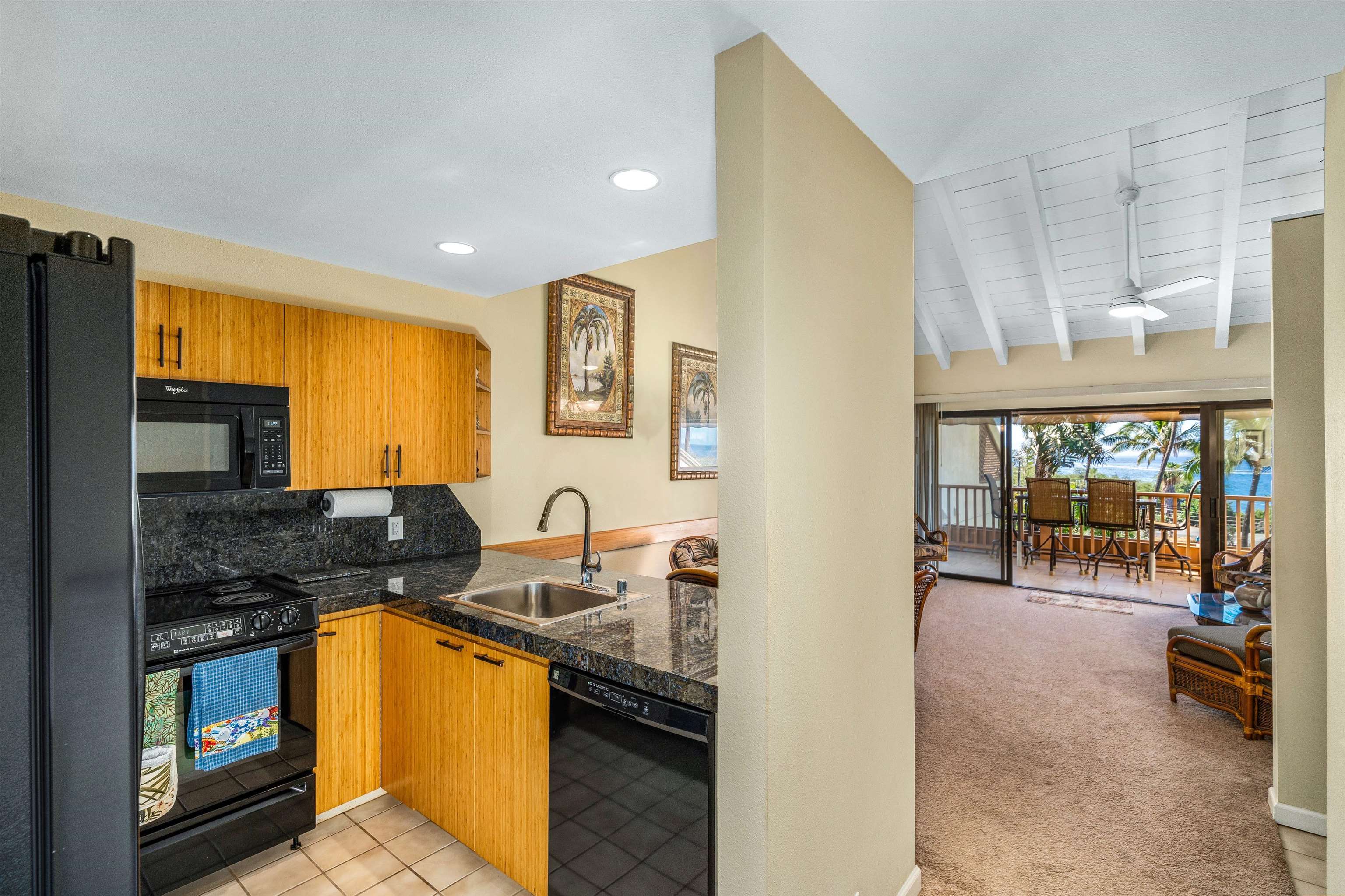 2777 South Kihei Road, Unit G207 Kihei, HI 96753 - Photo 10 of 50 a kitchen with stainless steel appliances granite countertop a stove a sink and a microwave