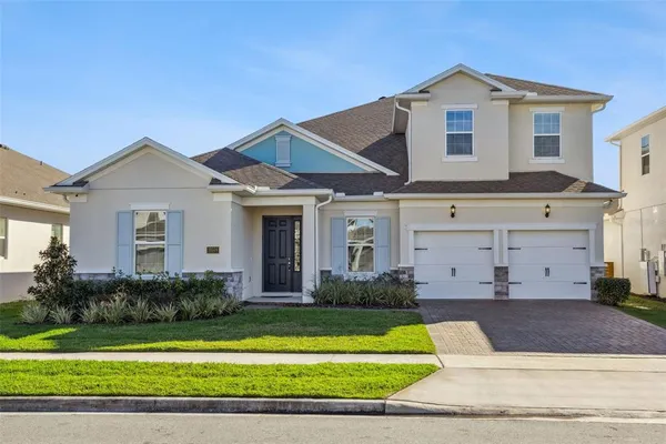 a front view of a house with a yard and garage