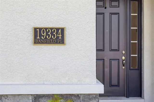 a living room with furniture and a ceiling fan
