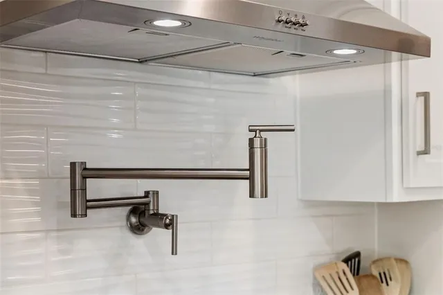 a bedroom with a bed a ceiling fan and a dresser