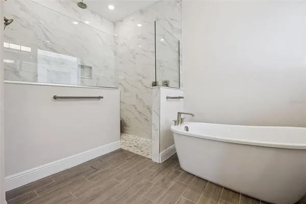 a bathroom with a sink a toilet a shower and a mirror