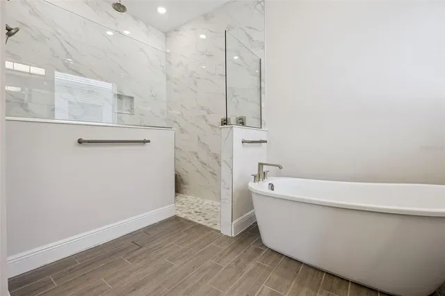 a bathroom with a sink a toilet a shower and a mirror